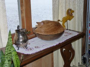 Cat sleeping in wooden bowl