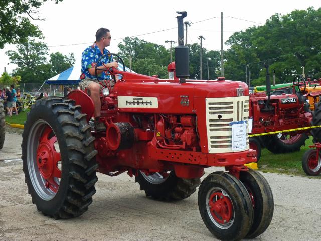 Vintage Red and White FarmAll Tractor in Sunday's Antique Tractor Parade at the fair