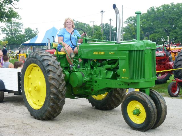 Vintage John Deere Tractor pulling passenger wagon in Sunday's Parade at the fair