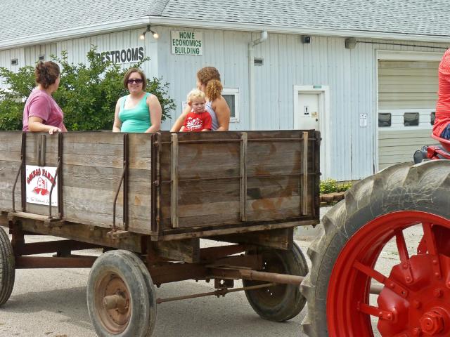 Passenger wagon being pulled by 1937 Farmall Tractor