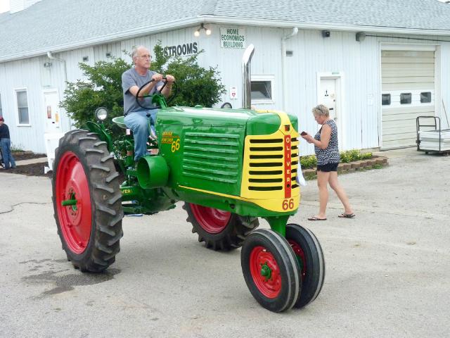 Green, Yellow, and Red Oliver 66 Row Crop Tractor in Monday's Parade at the fair