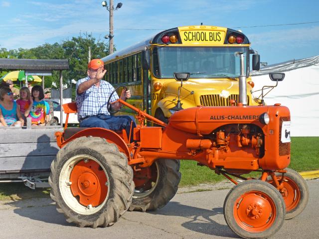 1947 Allis Chalmers D Tractor pulling surrey with a fringe on top in Wednesday's parade at the fair